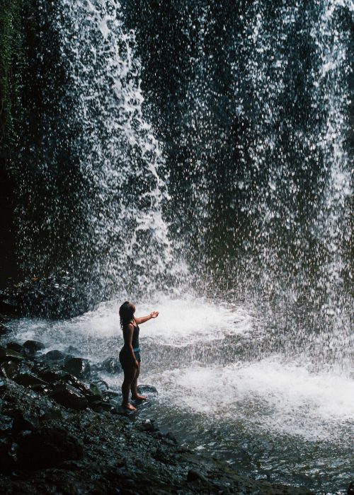Byron Bay Waterfall Woman at the bottom of a Byron Bay waterfall